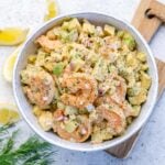 keto shrimp salad in a white bowl with celery and avocado