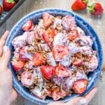 bowl of strawberry salad in hands