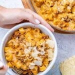 bowl of creamy beef pumpkin pasta in a hand